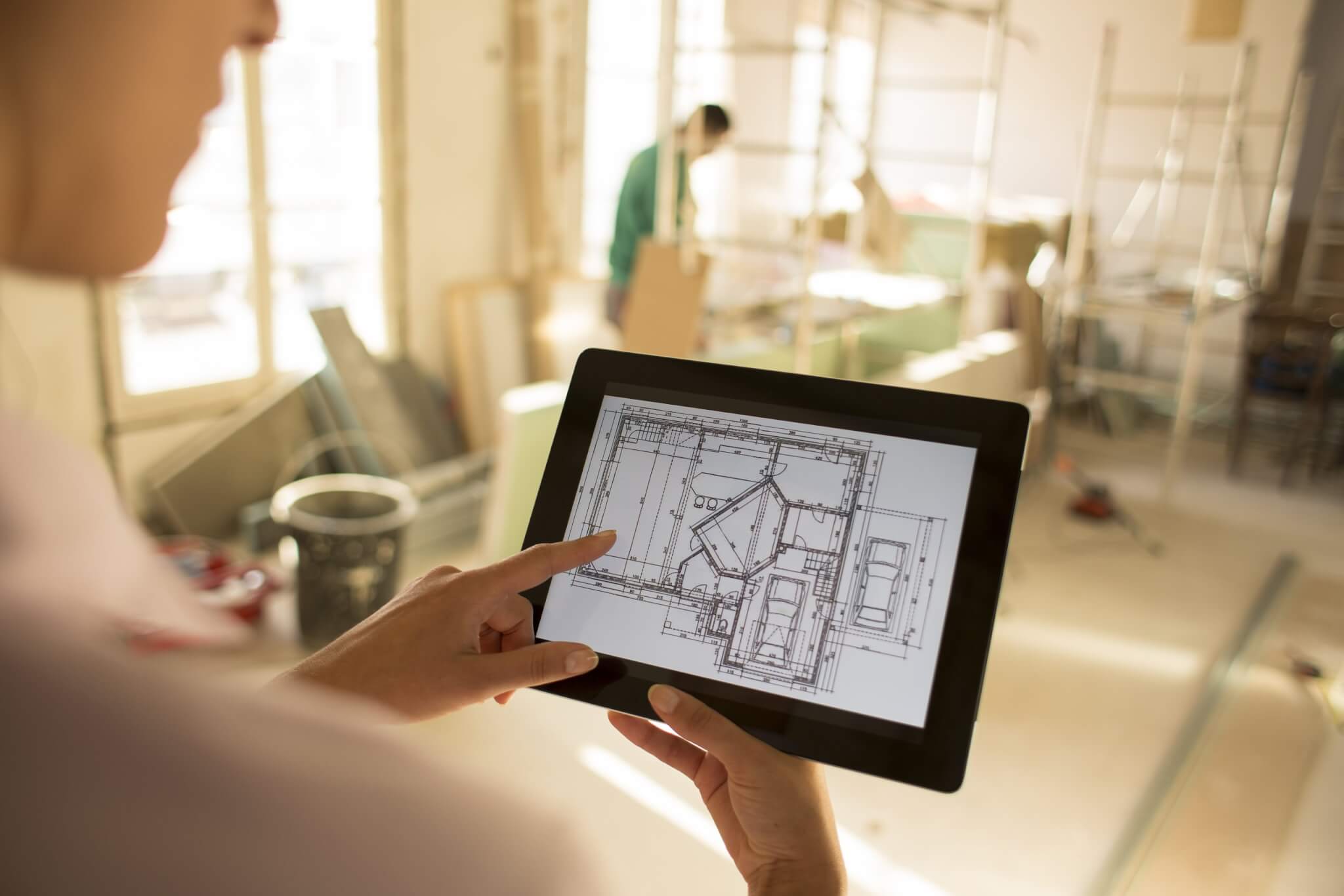 Architect woman working with electronic tablet An Engineering Document Management System